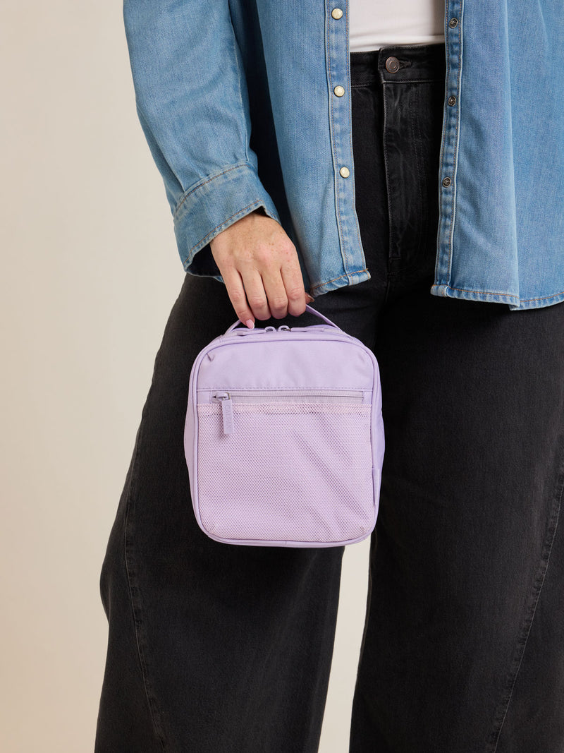 Model holding CALPAK Everything Cube in light purple Orchid