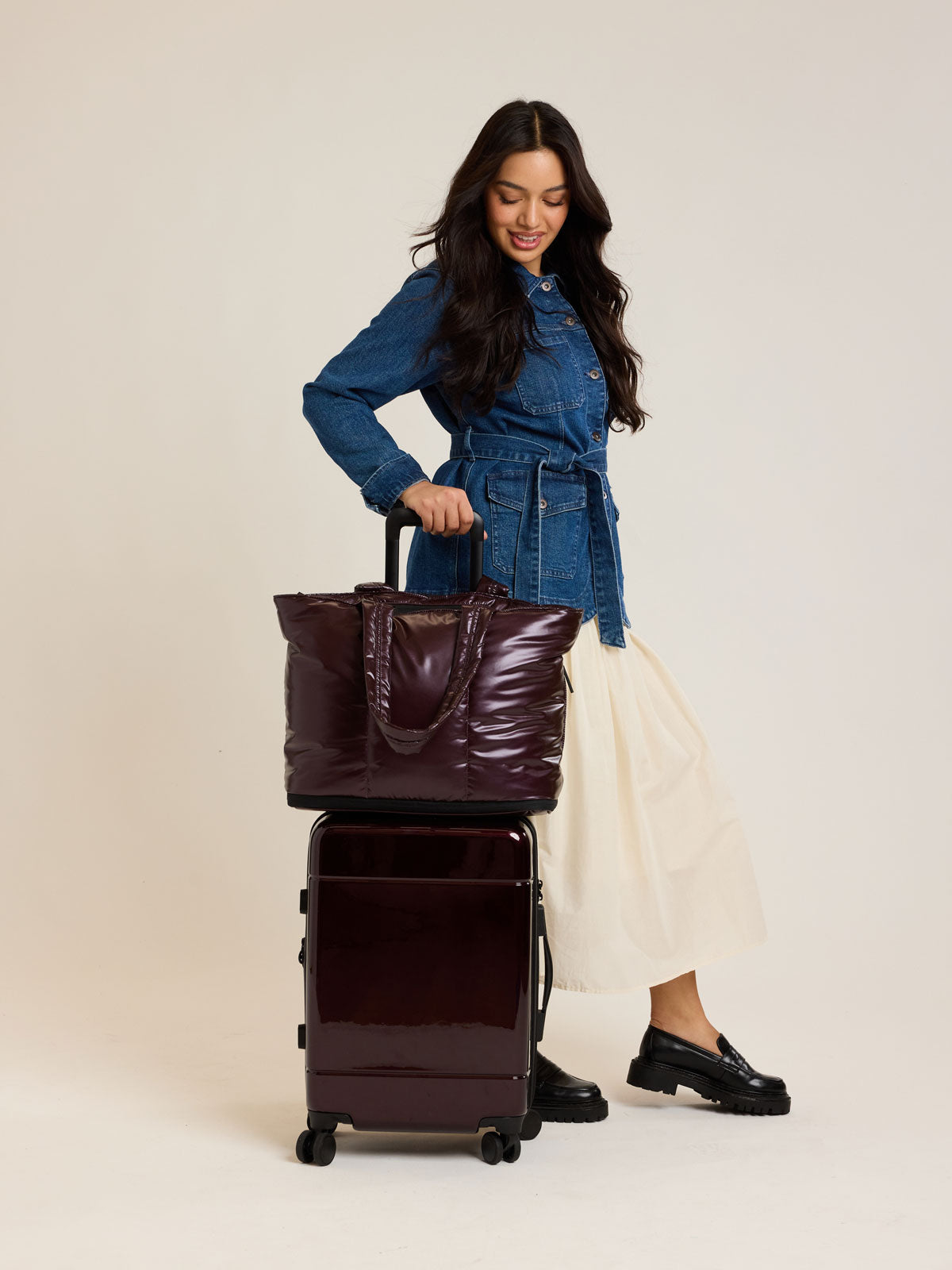 Model with CALPAK Luka Expandable Tote in maroon Dark Cherry; ALT2201-GLAZED-DARK-CHERRY