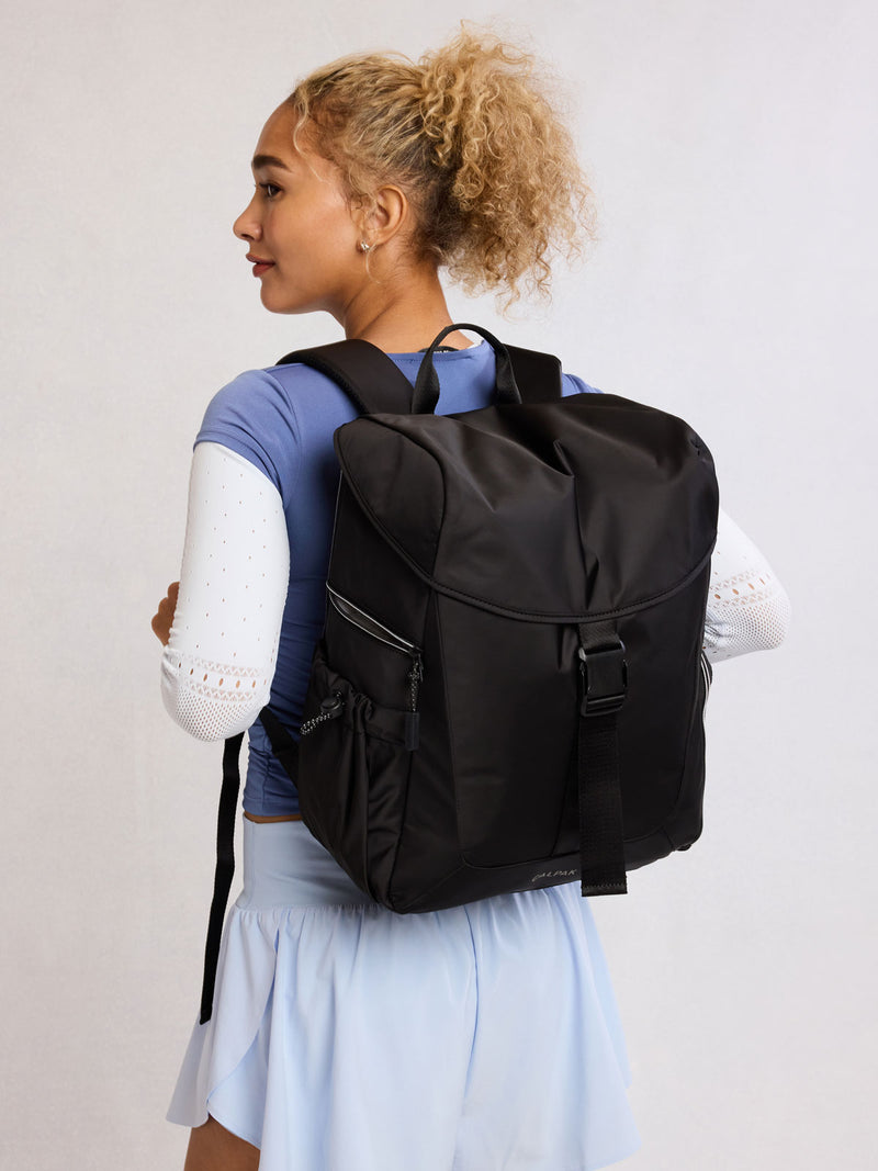 Model wearing CALPAK Fit Gym Backpack in Black front view with white background