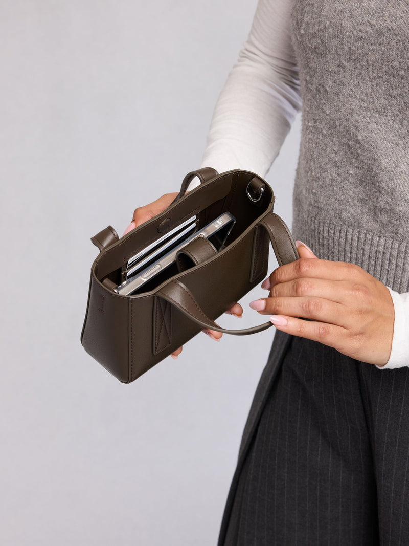 Opened view of CALPAK Haven Mini Crossbody Bag in dark brown Mushroom