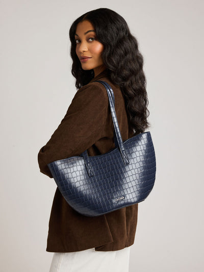 A navy blue crocodile-embossed CALPAK Haven Tulip tote bag with double shoulder straps against a plain white background; AHP2601-NAVY-FAUX-CROC view 2