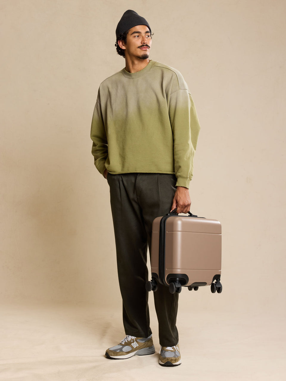 Model with CALPAK Hue Mini Carry On Luggage in brown Chocolate;  LHU1014-CHOCOLATE