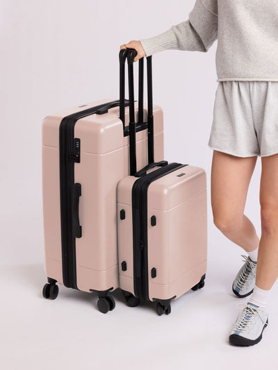 CALPAK Hue Large Luggage in light pink Rose Quartz with handle and wheels on a white background; LHU1028-ROSE-QUARTZ view 2
