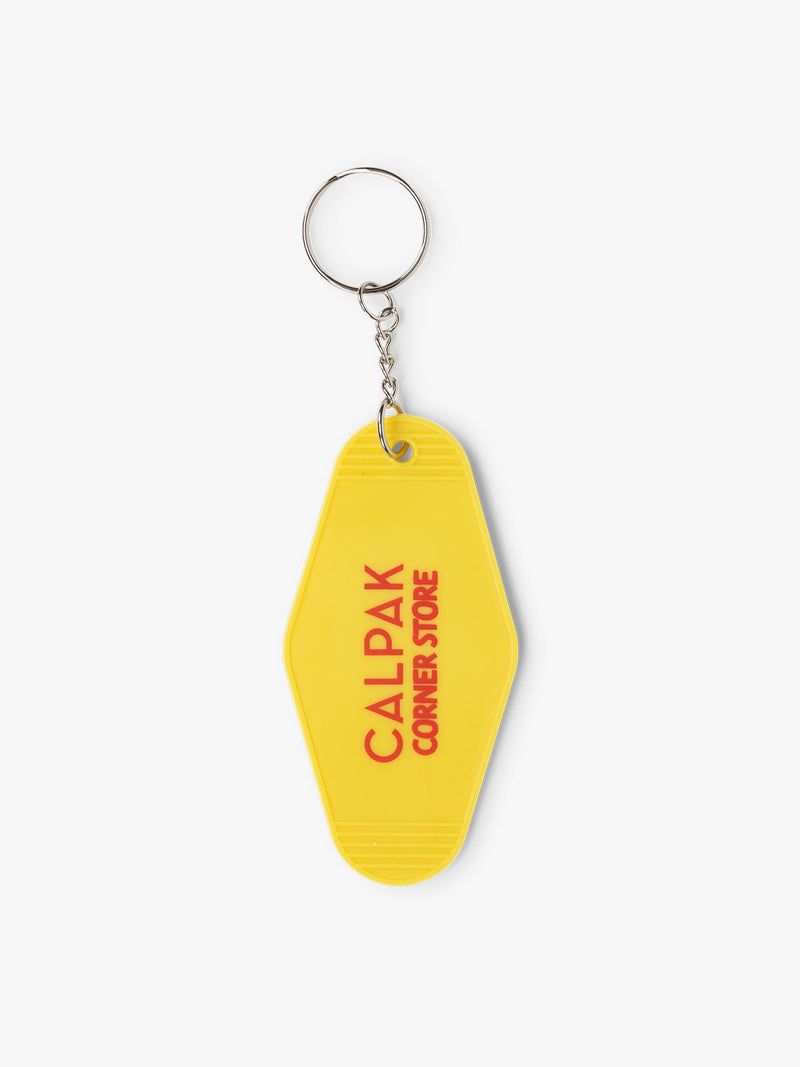 CALPAK yellow key chain with text in red reading CALPAK corner store
