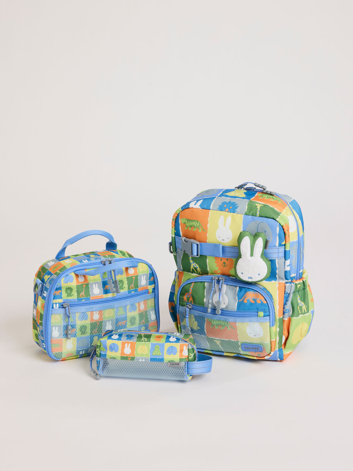 Colorful CALPAK + Miffy Kids Essentials Set with children's Small backpack, lunch bag , pencil case set on a white background with blue accents and Miffy with other animals; BCKS5000-MIFFY-BLUE-ZOO-TRIP