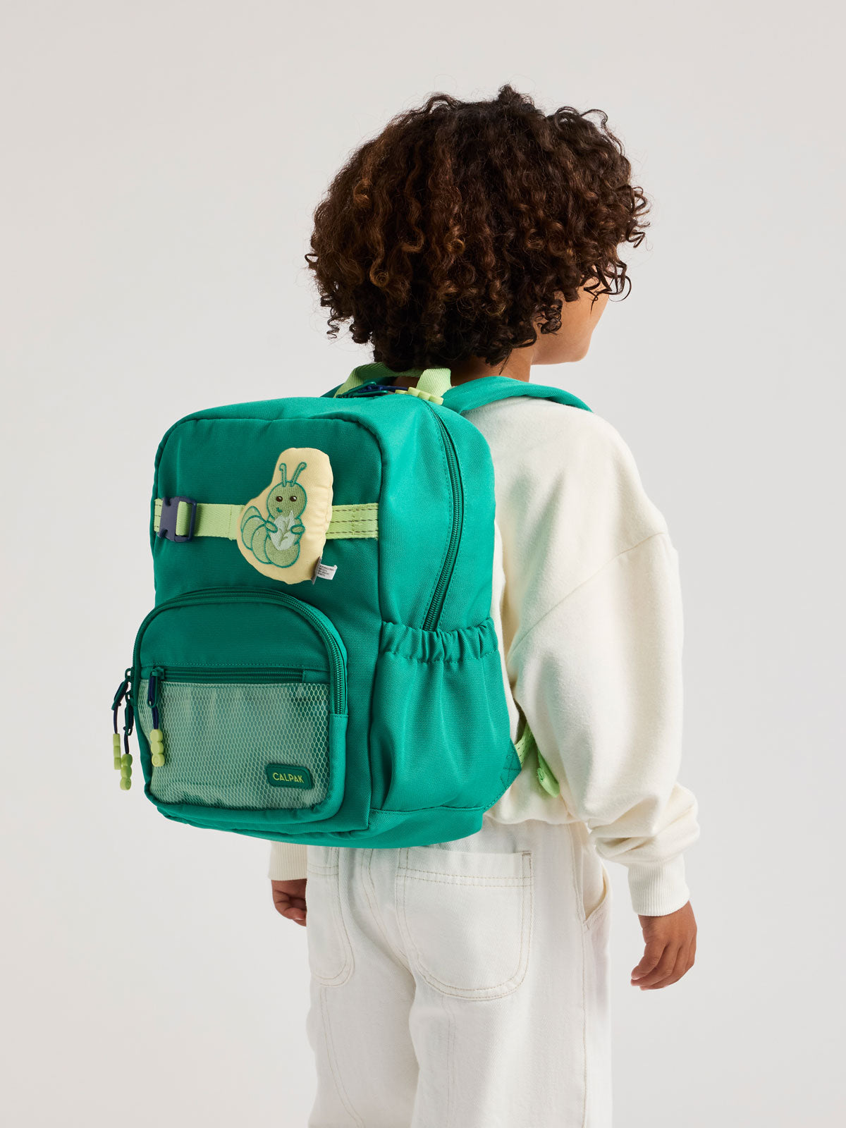 Children's Caterpillar CALKPAK Pluffy Bag Charm attached to a backpack; APLF2501-CATERPILLAR