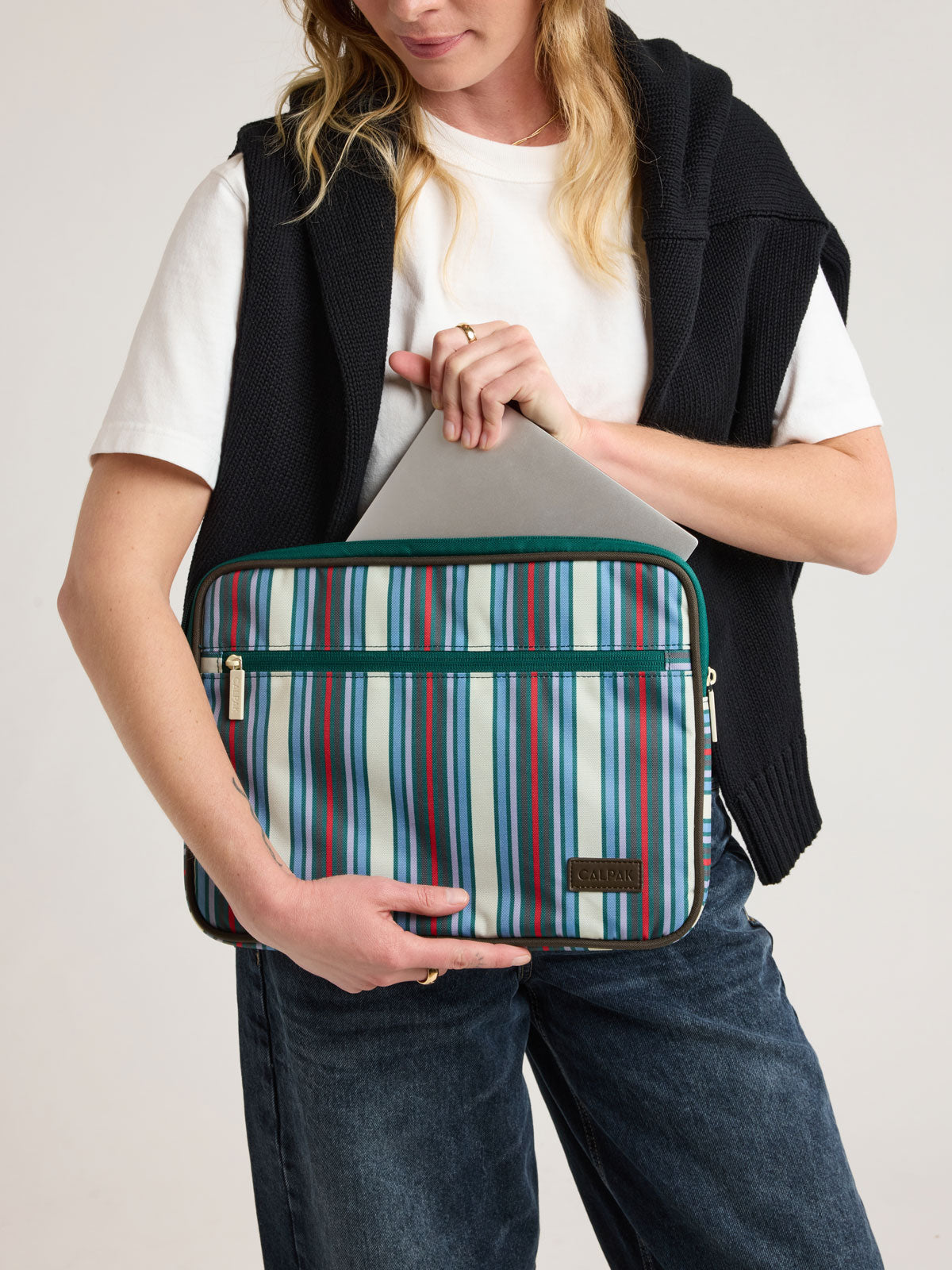 Person added laptop into CALPAK 13"-14" Padded Laptop Sleeve in multicolor stripes; ALP2213-RIVIERA-STRIPE