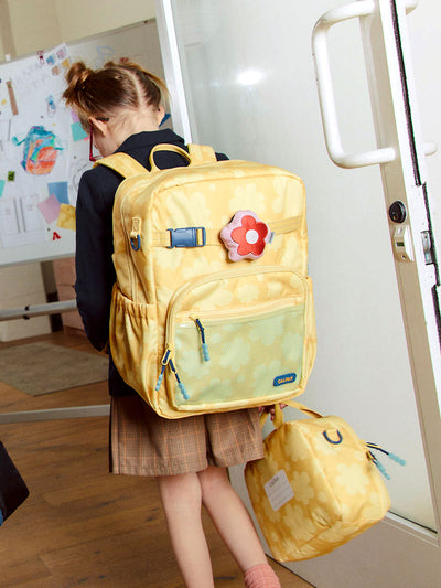 CALPAK Kids Large Backpack in yellow with tan flower print in Yellow Bloom for ages 8-12 side view with water bottle holder pocket; CKBL2501-YELLOW-BLOOM view 2