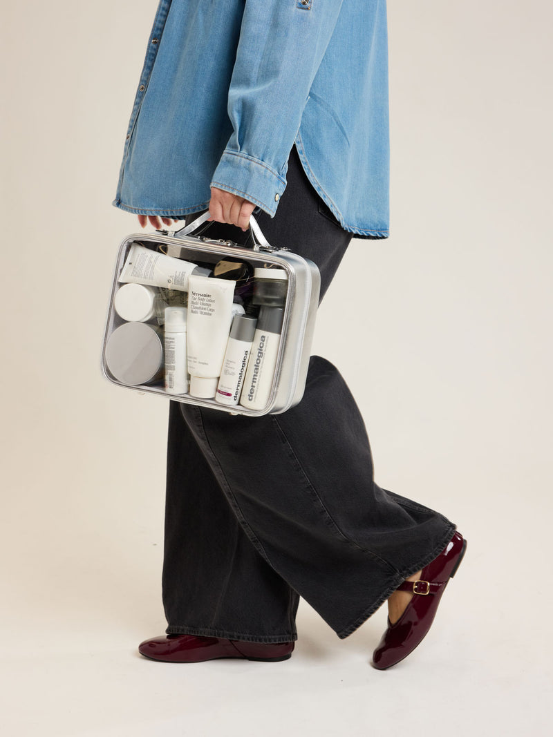 Model with CALPAK Large Clear Cosmetics Case in Silver