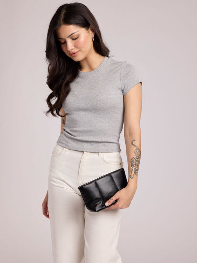 A CALPAK Luka 1 quart black vegan leather pouch bag with a quilted, padded design and a small black brand tag on the right side, shown against a plain white background; ZLPS2601-BLACK-PU view 2