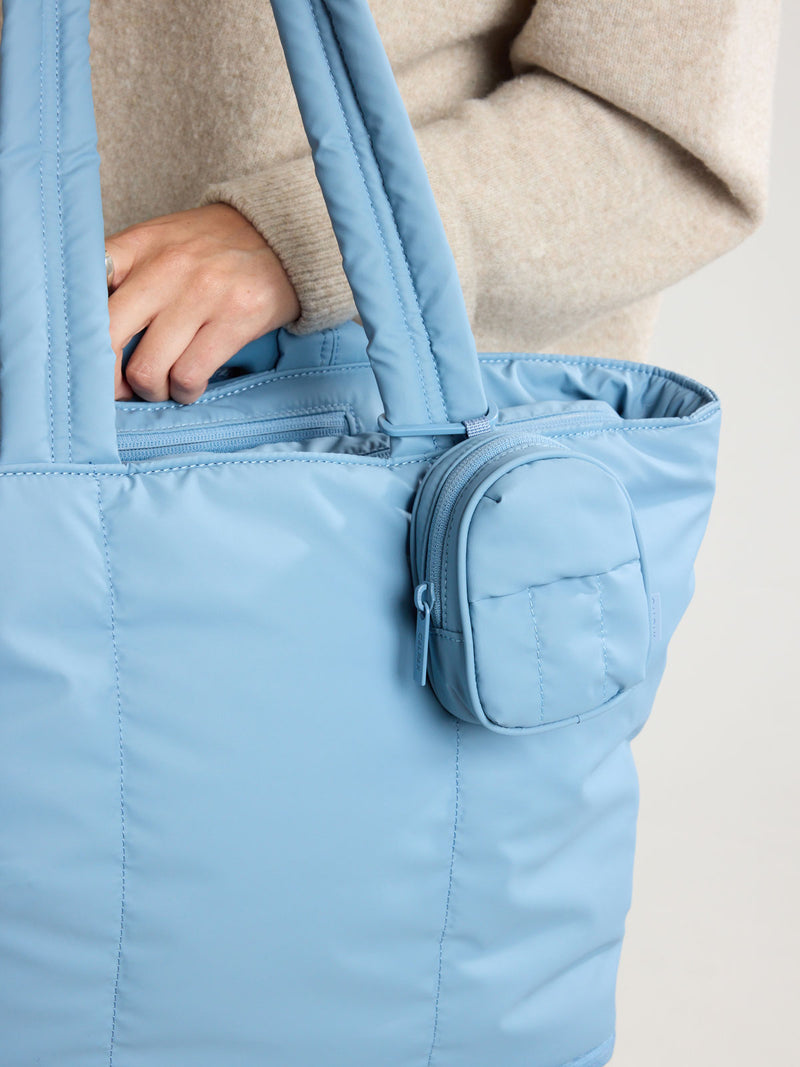 CALPAK Luka Backpack Zip Bag Charm in light blue French Blue clipped on bag