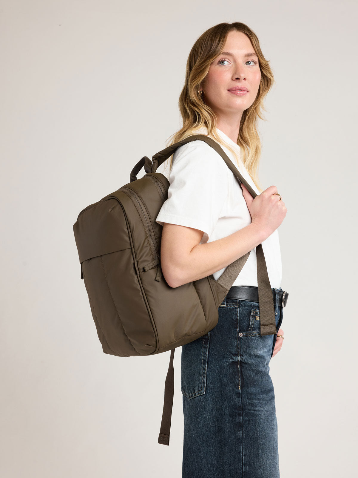 Woman wearing CALPAK Luka 15" Backpack in brown Mushroom; BPL2001-MUSHROOM