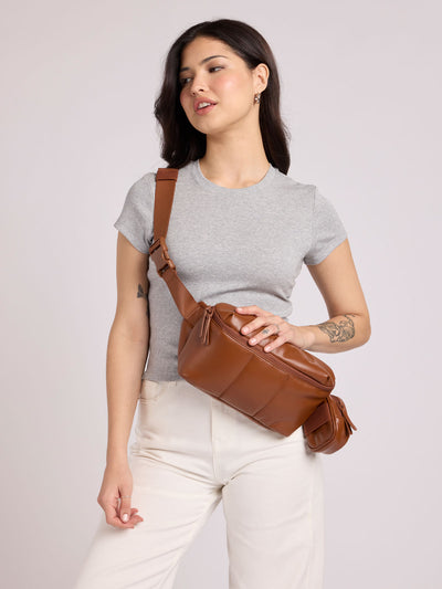 Light Honey Brown Mushroom vegan leather CALPAK Luka Belt Bag with a zippered front pocket and side straps, shown against a plain white background; BB1901-HONEY-BROWN-PU view 2