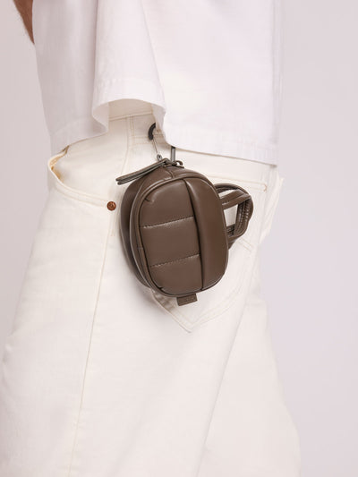 A dark brown Mushroom vegan leather top-handle CALPAK Luka Zip Bag Charm with a zippered front pocket and a small side strap, shown against a plain white background; ALK2501-MUSHROOM-PU view 2