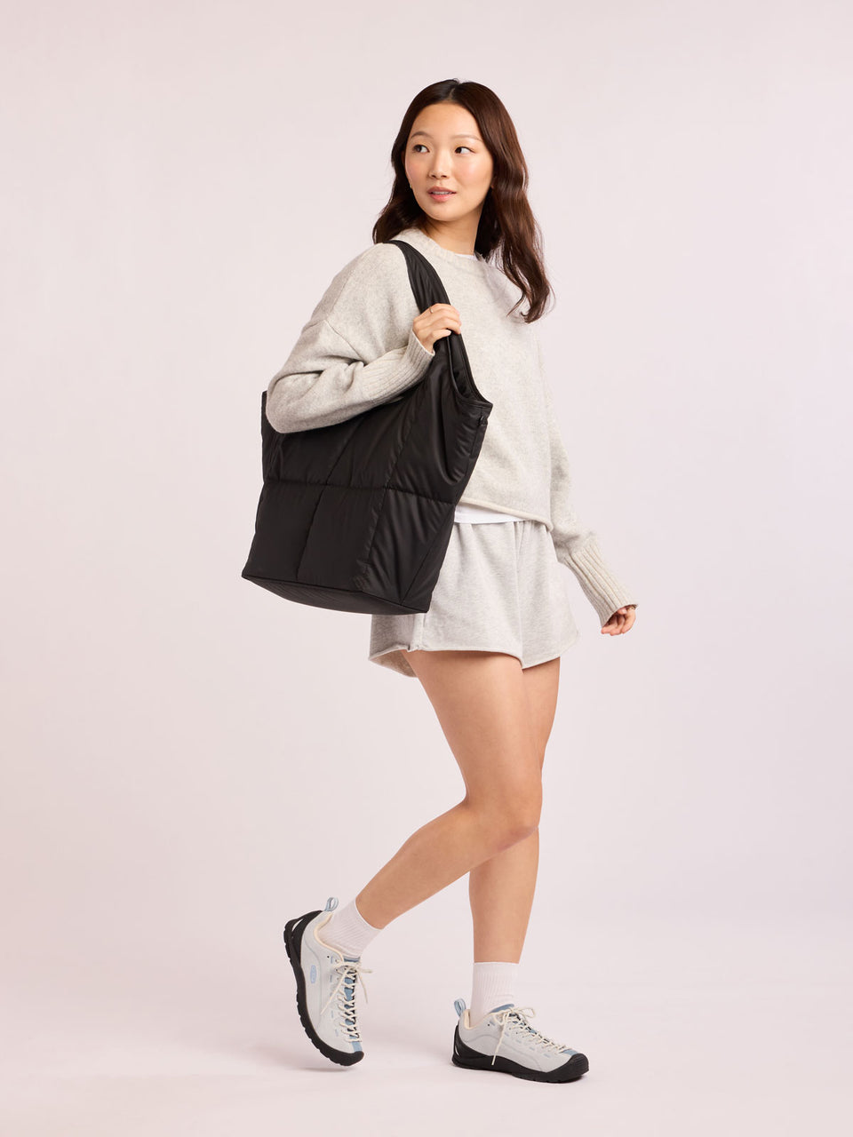 Model wearing CALPAK Luka Everything Tote in black; AET2601-MATTE-BLACK