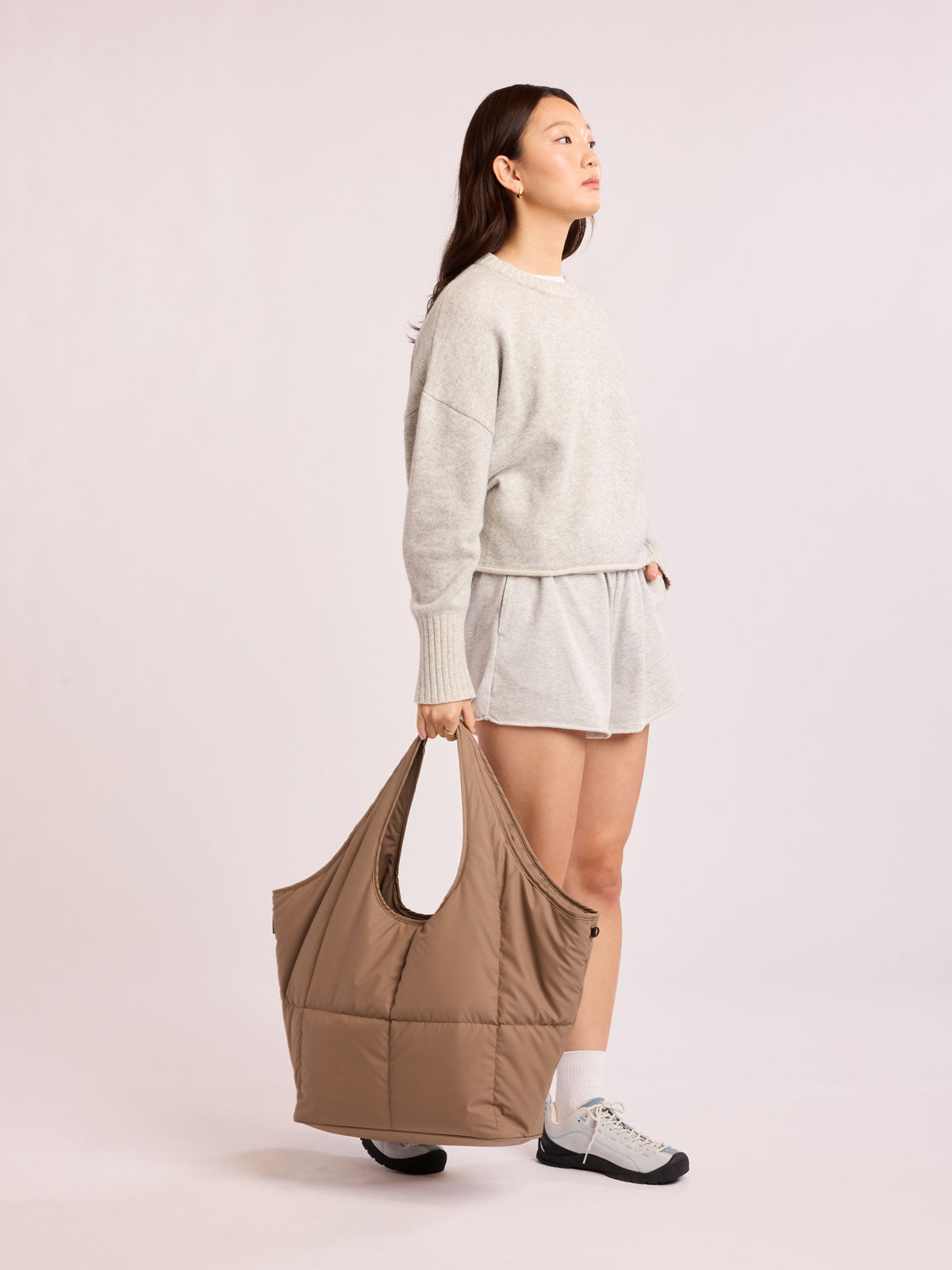 Model carrying CALPAK Luka Everything Tote in brown Chocolate; AET2601-CHOCOLATE