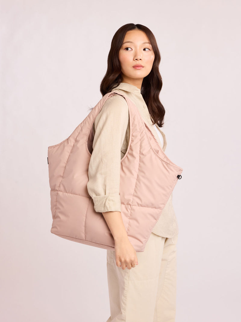 Woman with CALPAK Luka Everything Tote in light pink Rose Quartz