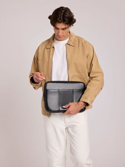 Black vegan leather CALPAK Luka 14in Laptop Sleeve with a zippered top and a front pocket, shown against a plain white background; ALL2401-BLACK-PU view 2