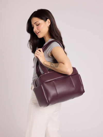 Dark burgundy Dark Cherry vegan leather CALPAK Luka Mini Duffel with dual top handles and side pockets, photographed against a clean white background; DLM2501-DARK-CHERRY-PU view 2