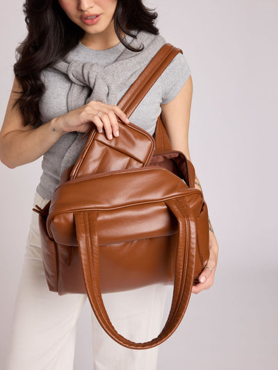 Honey brown vegan leather CALPAK Luka Mini Duffel with dual top handles and side pockets, photographed against a clean white background; DLM2501-HONEY-BROWN-PU view 2