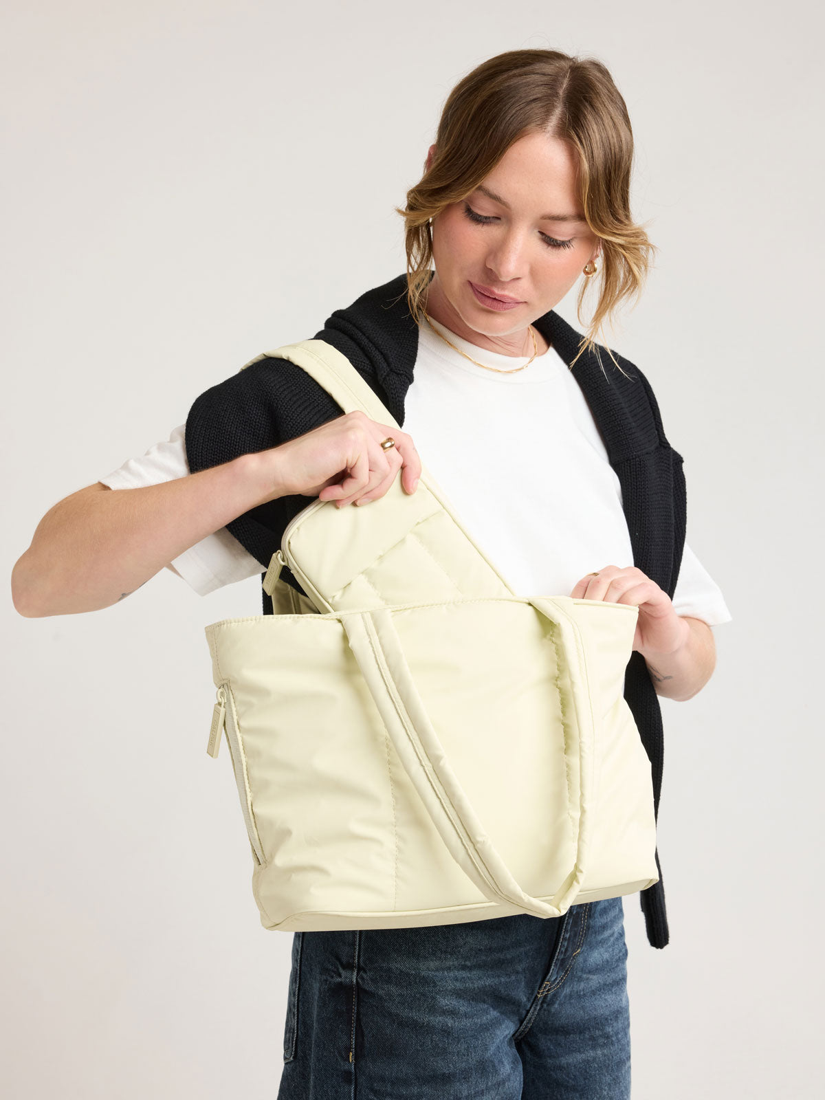 Modeling  wearing CALPAK Luka Mini Tote in light green Celadon; ALM2401-CELADON