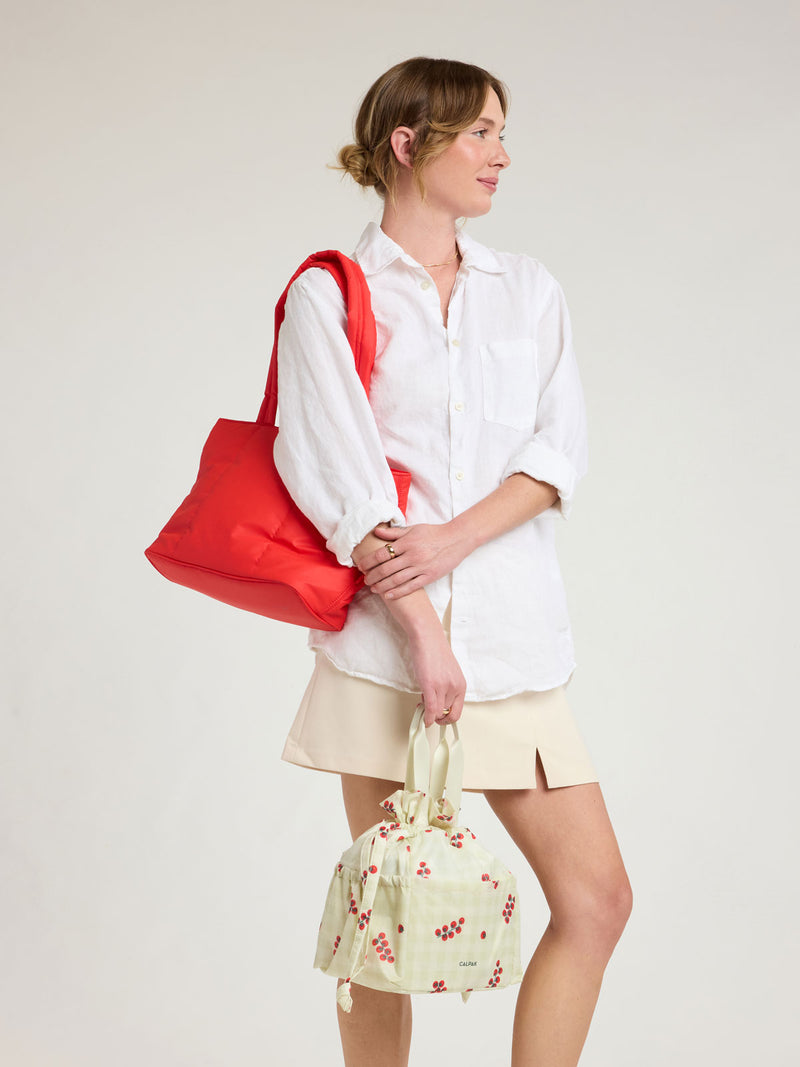 Model wearing CALPAK Luka Mini Tote in red Tomato