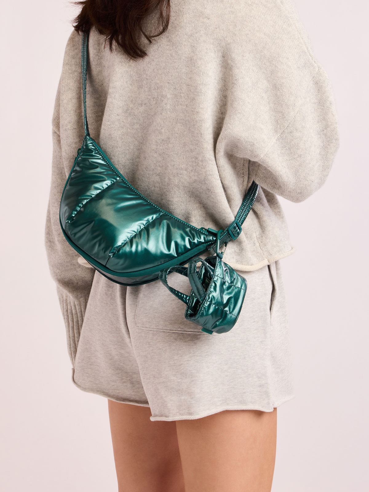 Model with bag with CALPAK Luka Tote Zip Bag Charm in dark green shiny Glazed Kale clipped on bag; AMT2601-GLAZED-KALE
