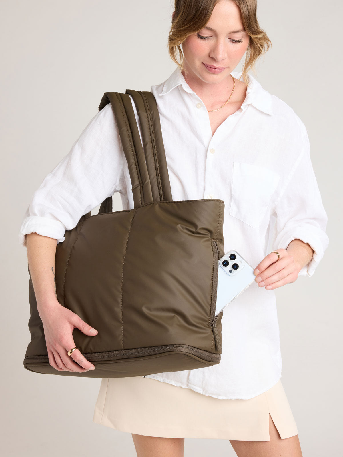 Person with CALPAK Luka Expandable Tote in brown Mushroom; ALT2201-MUSHROOM