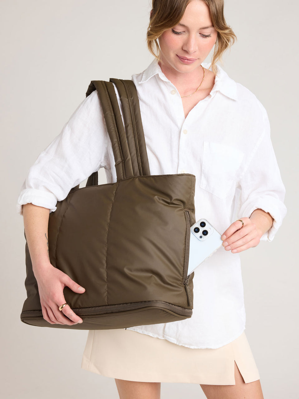 Person with CALPAK Luka Expandable Tote in brown Mushroom; ALT2201-MUSHROOM