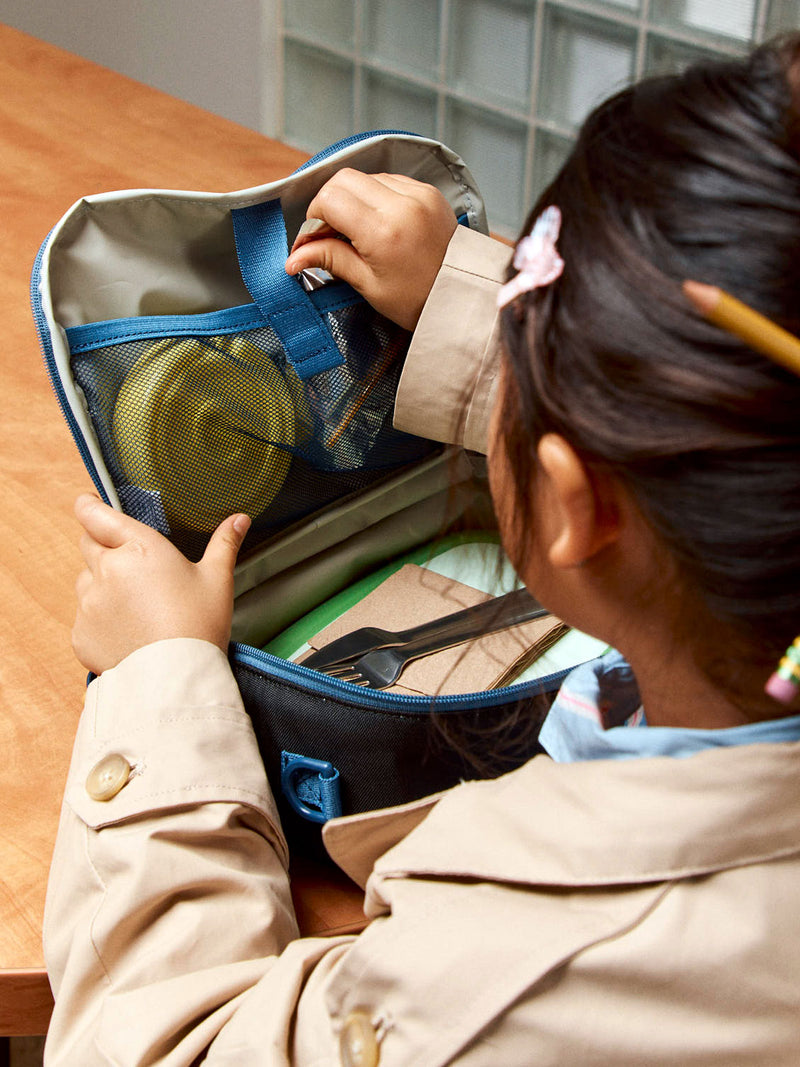 CALPAK Kids Lunch Bag in Black opened view as child is packing lunch