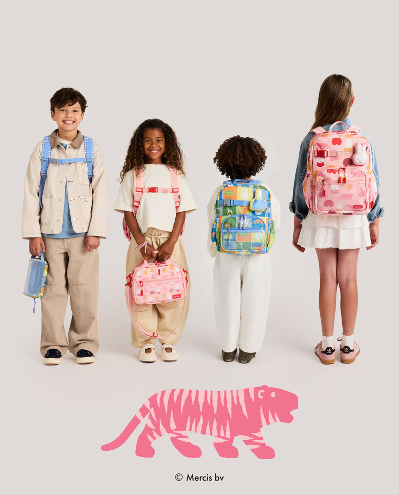Four children standing against a light gray studio background, each wearing or holding a colorful patterned backpack and a matching small pouch. The children are shown from mixed front and back angles.