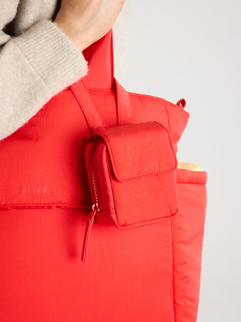 CALPAK Pacifier Pouch in red Tomato on a bag strap