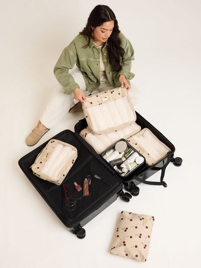 CALPAK Packing Cubes 5pc Set in beige with cherry print in Oatmeal Cherry on a white background; PC1601-OATMEAL-CHERRY view 2