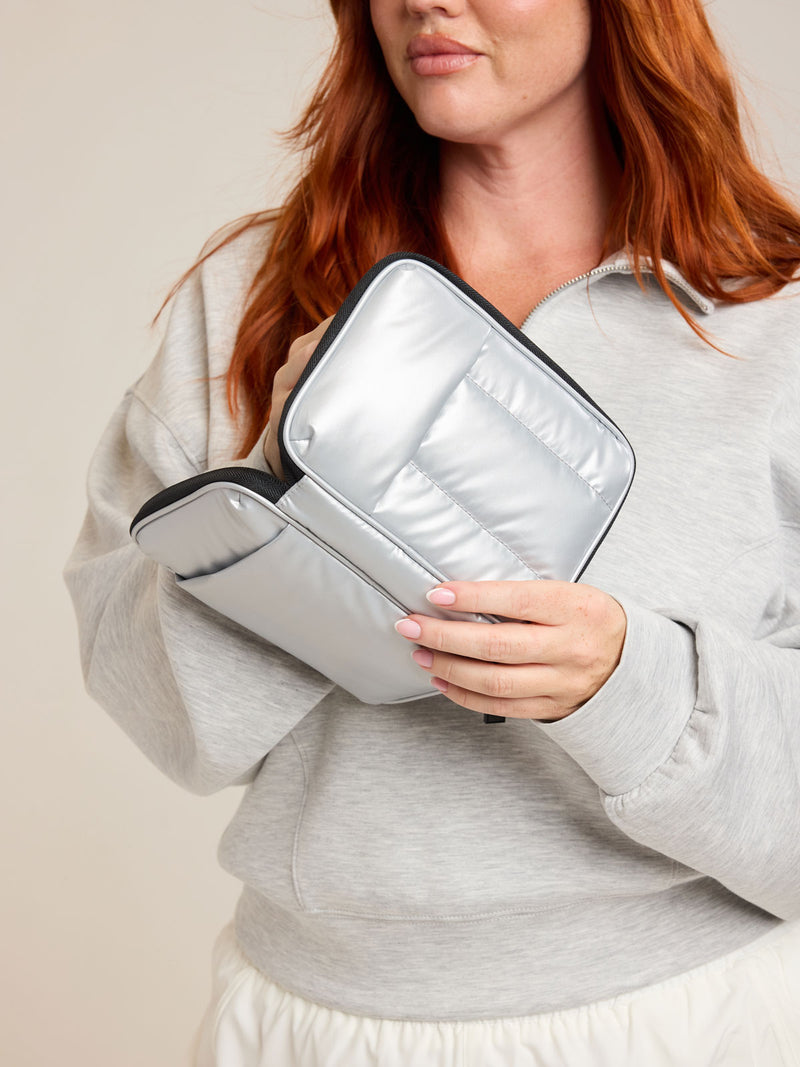 Model opening CALPAK Luka Zippered Passport Wallet in Silver