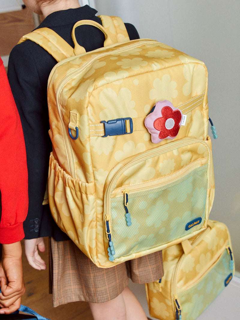 CALPAK Kids Pluffy Bag Charm red Flower on pink plush attached to Kids Backpack in Yellow Bloom