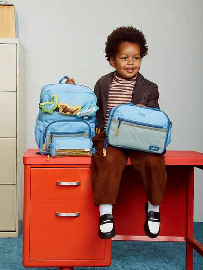 CALPAK Kids Small Backpack in Blue for ages 3-5 is built for your little one’s big days with dark blue zippers and yellow mesh front pocket, multiple interior pockets for an 11” tablet or laptop, and padded comfort straps; CKBS2501-BLUE view 2