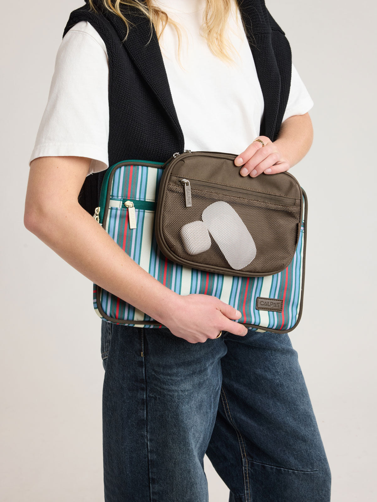 Person holding CALPAK Tech Organizer in brown Mushroom; ATC2001-MUSHROOM