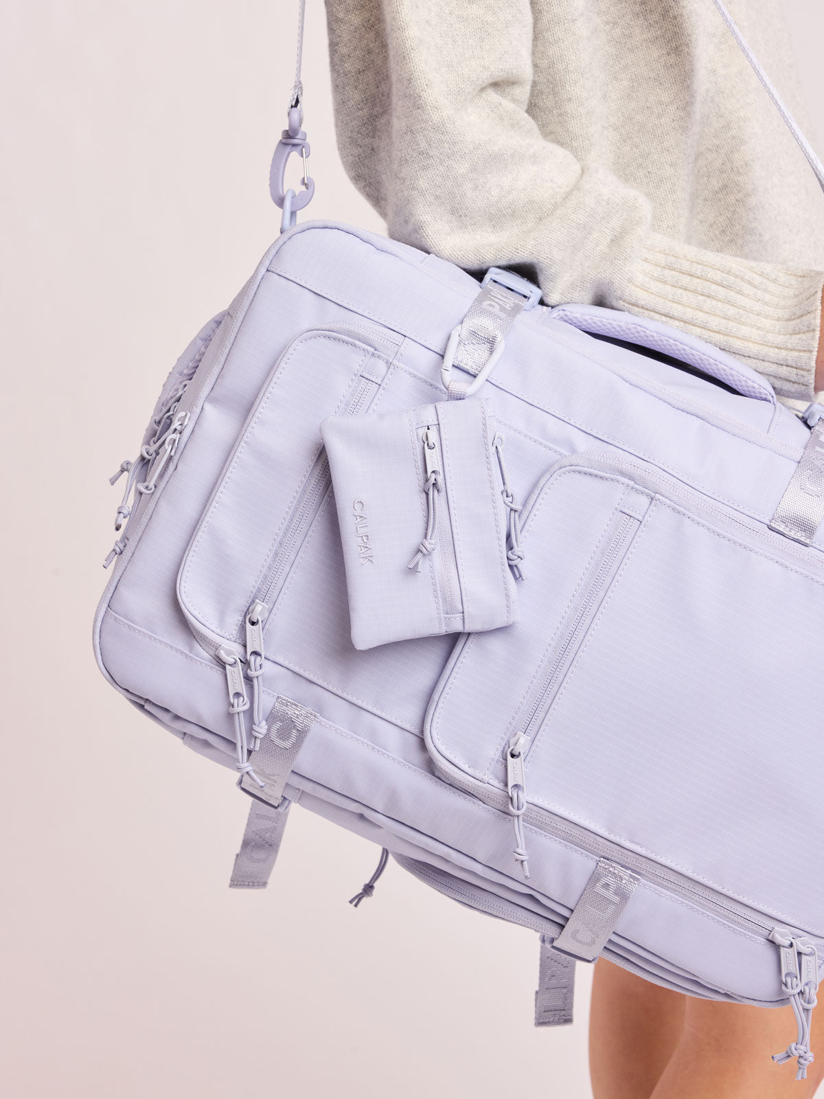 CALPAK Terra Clippable Card Pouch in light purple lavender Sea Glass on a white background with a carabiner clipped on bag; TPC2401-SEA-GLASS