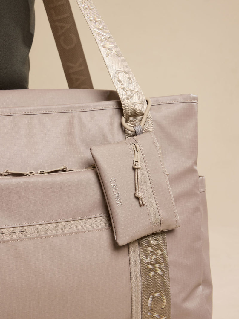 CALPAK Terra Clippable Card Pouch in beige Stone clipped onto bag