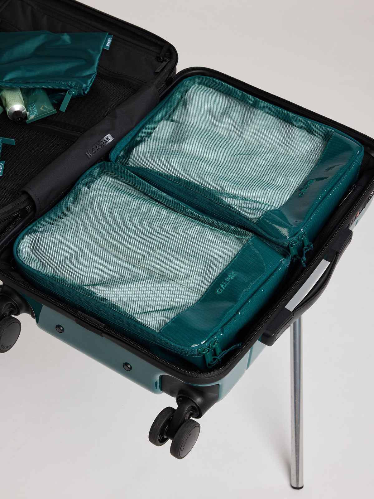 CALPAK Terra 5pc Packing Cube Set in blue green Kale packed in a suitcase; PCT2601-KALE