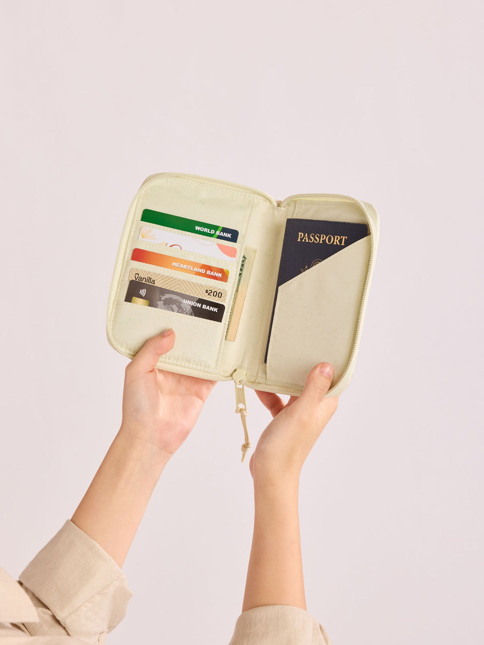 Opened Front side of CALPAK Terra Zip Passport Wallet in shiny white Moonbeam; ATPW2501-MOONBEAM
