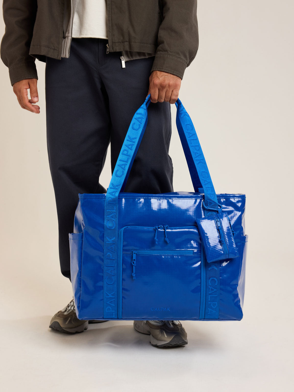 Model with CALPAK Terra 35L Tote in blue Cobalt; TTO2401-COBALT