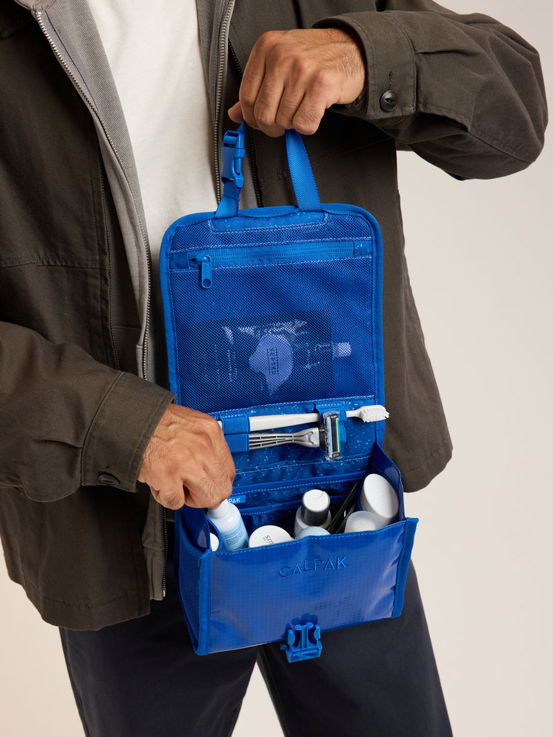 Model with CALPAK Terra Hanging Toiletry Bag in blue Cobalt