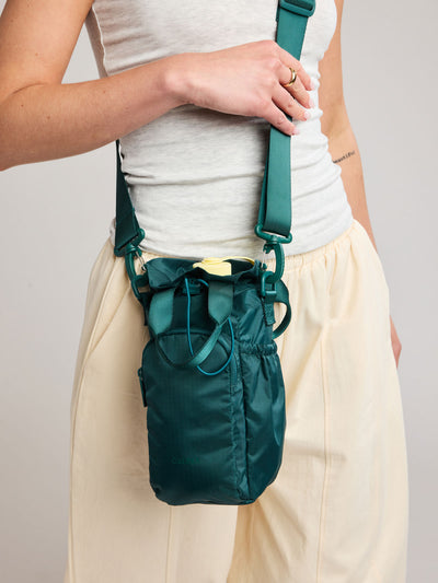 Dark green teal Kale CALPAK Water Bottle Holder with top handles, drawstring top, front zippered pocket, and a detachable shoulder strap; AWH2101-KALE view 2