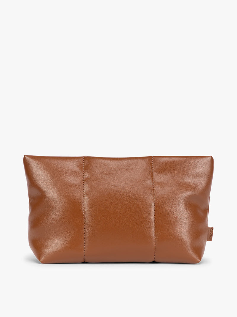 CALPAK light brown Honey Brown vegan leather pouch bag with a structured rectangular shape and vertical stitched panel details, shown against a plain white background