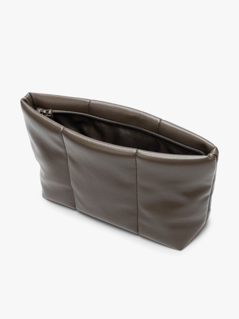Opened zipper of CALPAK dark brown Mushroom vegan leather pouch bag with a structured rectangular shape and vertical stitched panel details, shown against a plain white background