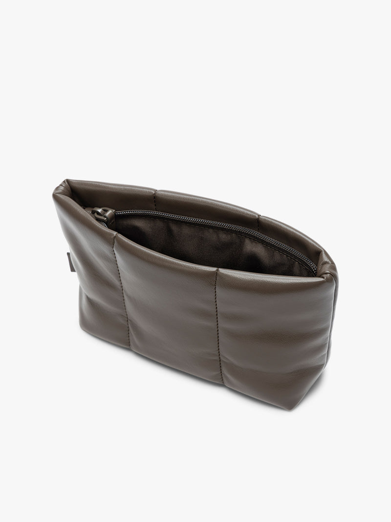 Opened zipper of  CALPAK Luka 1 quart brown Mushroom vegan leather pouch bag with a quilted, padded design and a small brand tag on the right side, shown against a plain white background
