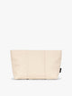 Beige Oatmeal colored CALPAK Luka 1 Quart Pouch with vertical stitched paneling and top zipper, shown against a plain white background; ZLPS2601-OATMEAL