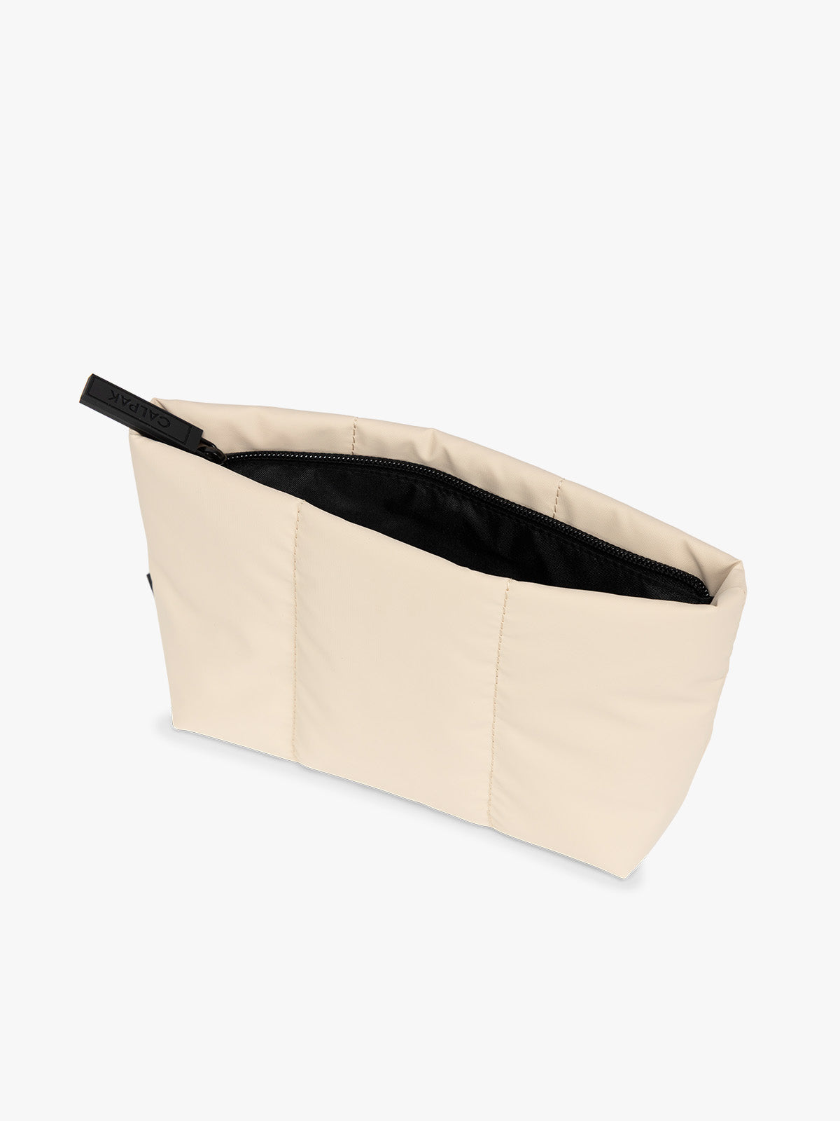 Top side view of beige Oatmeal colored CALPAK Luka 1 Quart Pouch with vertical stitched paneling and top zipper, shown against a plain white background; ZLPS2601-OATMEAL