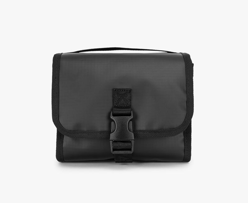 Matte Black Terra Hanging Toiletry Bag with a buckle on a white background